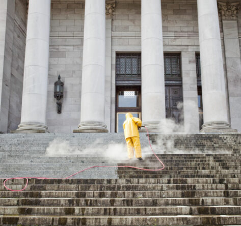 Person cleaning the steps at the Washington State Capitol Building in Olympia, Washington.
